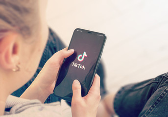 Someone holding a phone with TikTok open